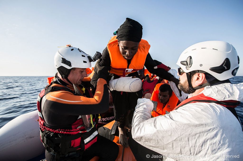 injured-woman-migrant-being-helped-in-Central-Mediterranean-copyright-Jason-Florio_MOAS-2016-5229