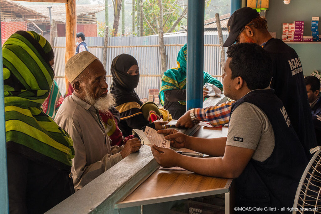 Rohingya people collect their medication from the MOAS pharmacy at the Shamlapur Aid Station.