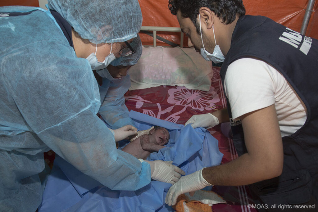 In November 2017, the first baby to be born in a MOAS Aid Station was delivered. Here, MOAS medics make initial checks to ensure the baby is healthy.